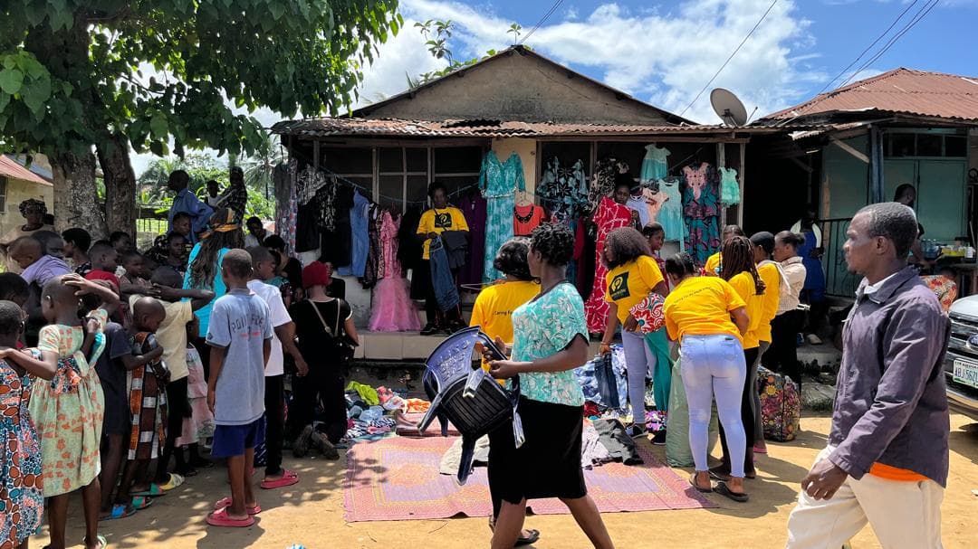 Large crowd and volunteers coordinating distribution at a neighborhood collection point